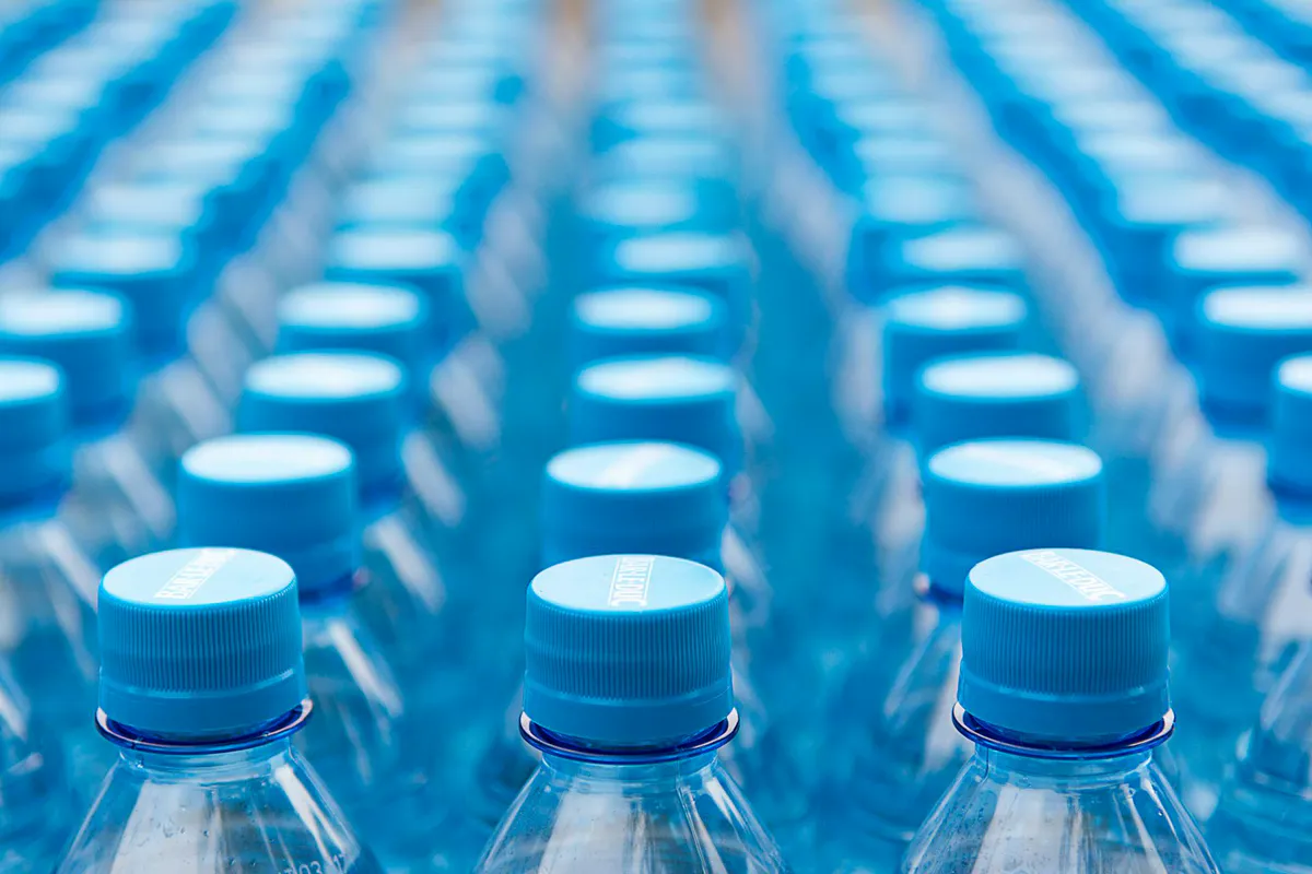 An array of capped plastic water bottles arranged in a grid pattern, representing a stored water supply
